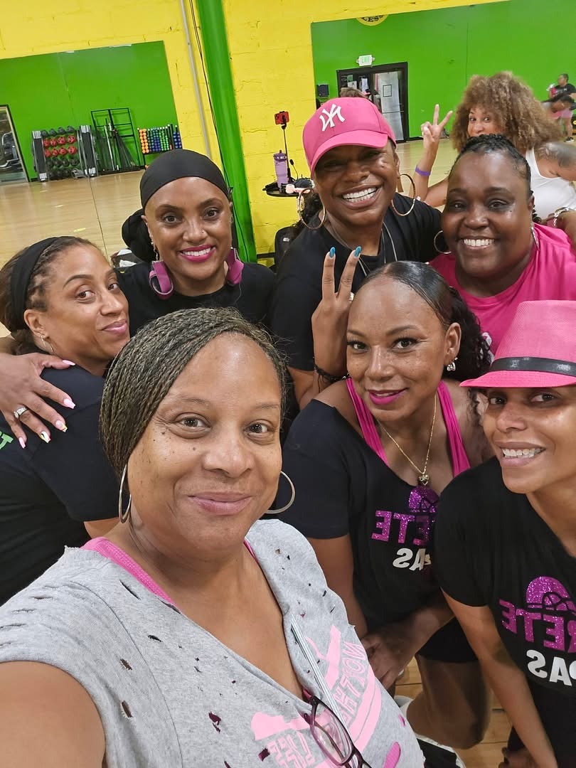 Concrete Steppa Nation™ group selfie in a gym, with people smiling in pink and black clothing.